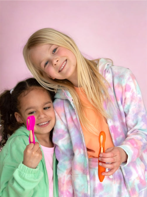 Pink toothbrush and cover plus orange toothbrush and cover 